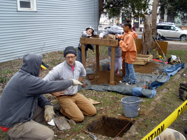 Corey and assistant discuss moving their dig